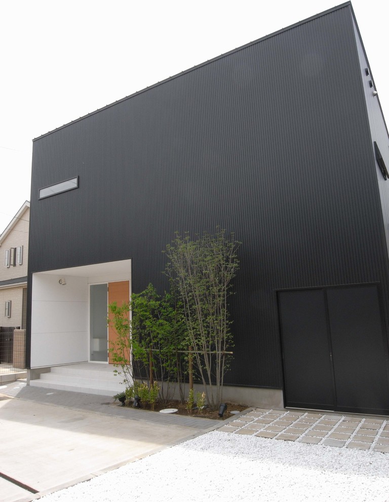 Ispirazione per la facciata di una casa nera moderna a due piani con rivestimento in metallo e copertura in metallo o lamiera