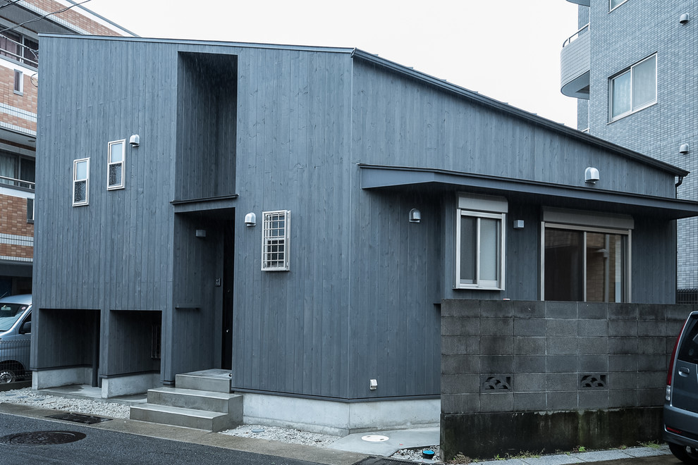 Idee per la facciata di una casa piccola nera etnica a due piani con rivestimento in legno e copertura in metallo o lamiera