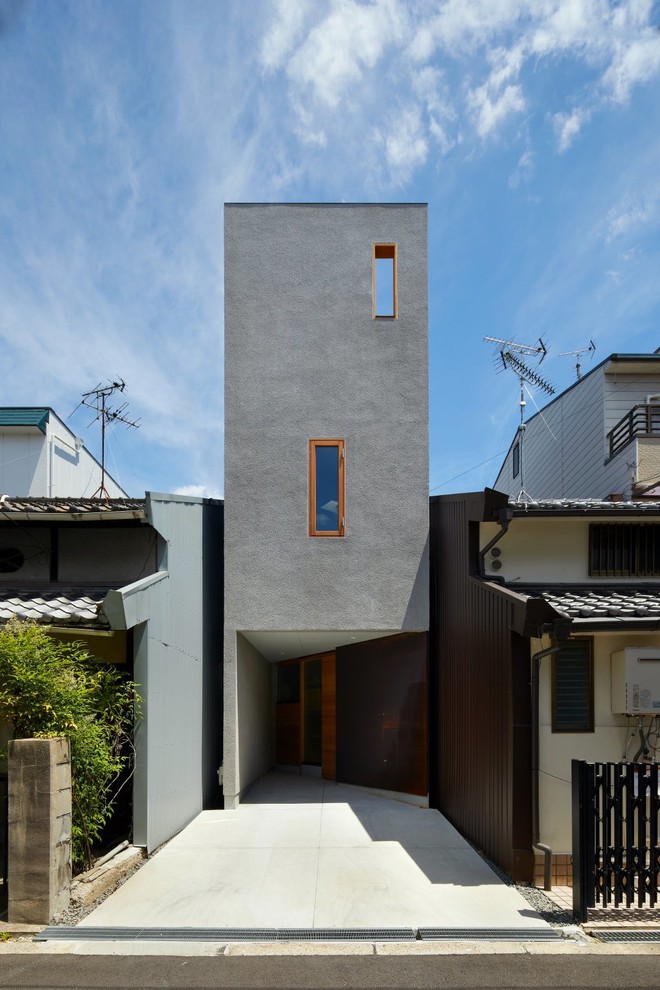 Réalisation d'une façade de maison grise minimaliste.