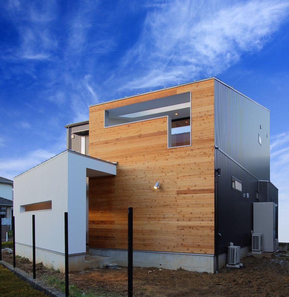 Inspiration for a contemporary gray two-story metal house exterior remodel in Other with a shed roof and a metal roof