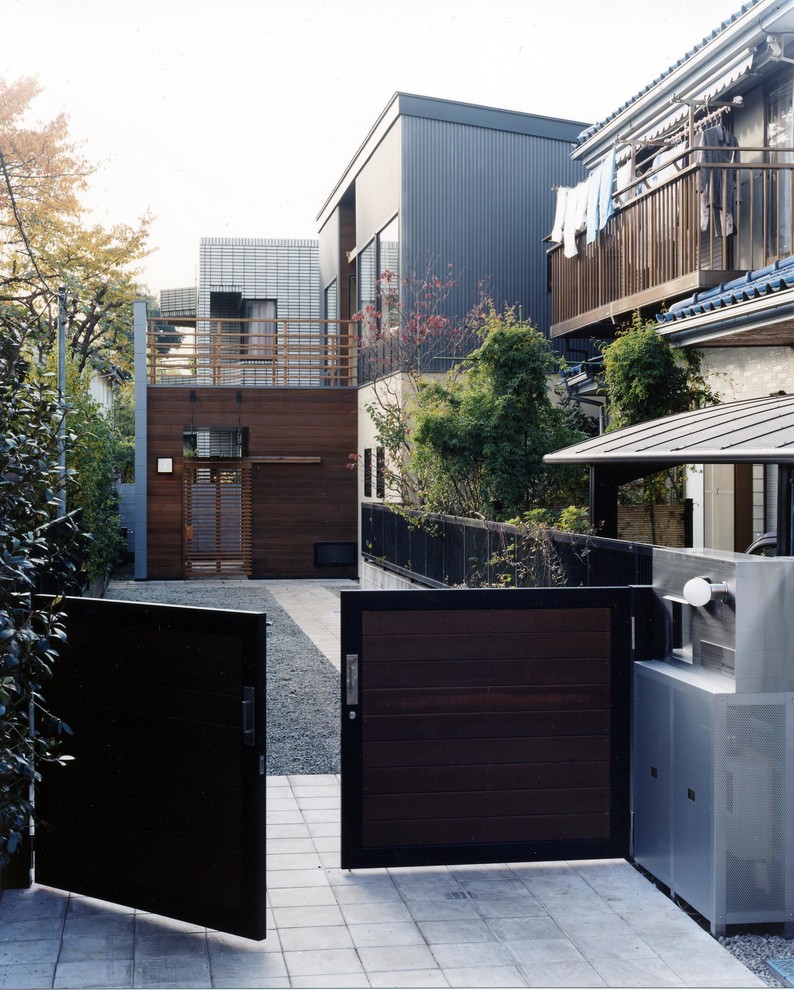 Inspiration for a modern black two-story metal exterior home remodel in Tokyo with a shed roof