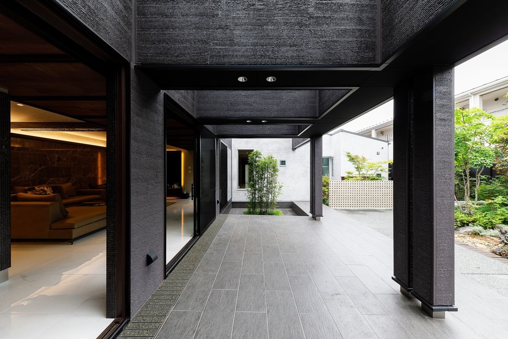 Huge contemporary black one-story exterior home idea in Osaka with a metal roof