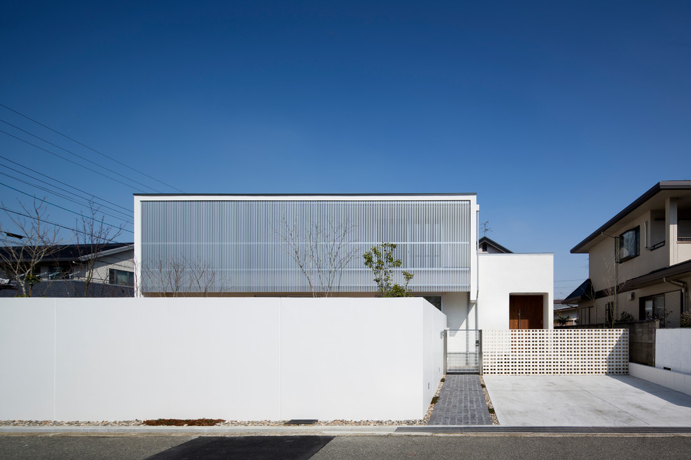Inspiration for a white modern two floor house exterior in Osaka with a flat roof.