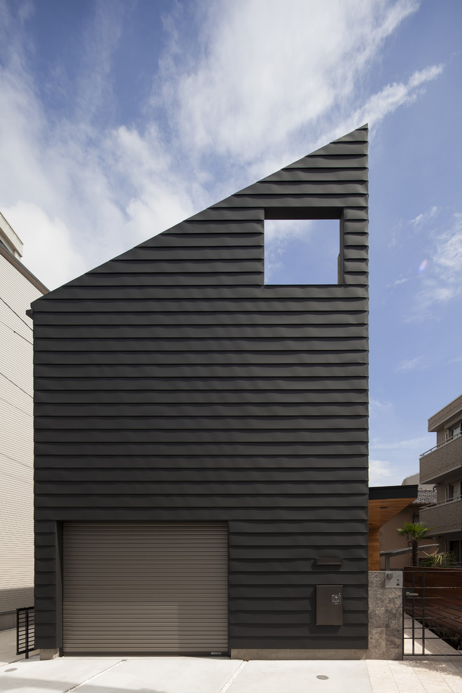Black contemporary detached house with a lean-to roof.