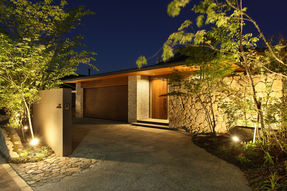 Foto de fachada de casa marrón minimalista grande de dos plantas con revestimiento de piedra, tejado a dos aguas y tejado de metal