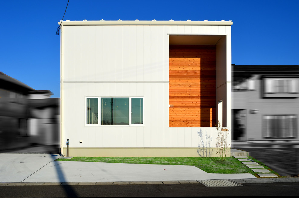 Immagine della facciata di una casa piccola bianca scandinava a due piani con rivestimento in metallo e copertura in metallo o lamiera