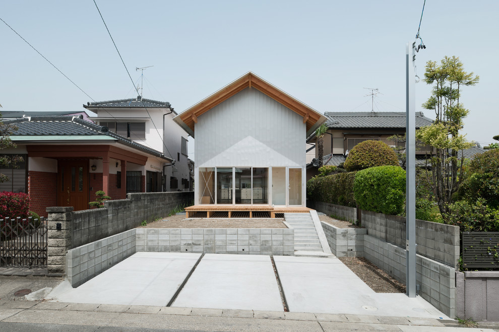 Photo of a medium sized and white world-inspired two floor detached house in Nagoya with metal cladding, a pitched roof and a metal roof.