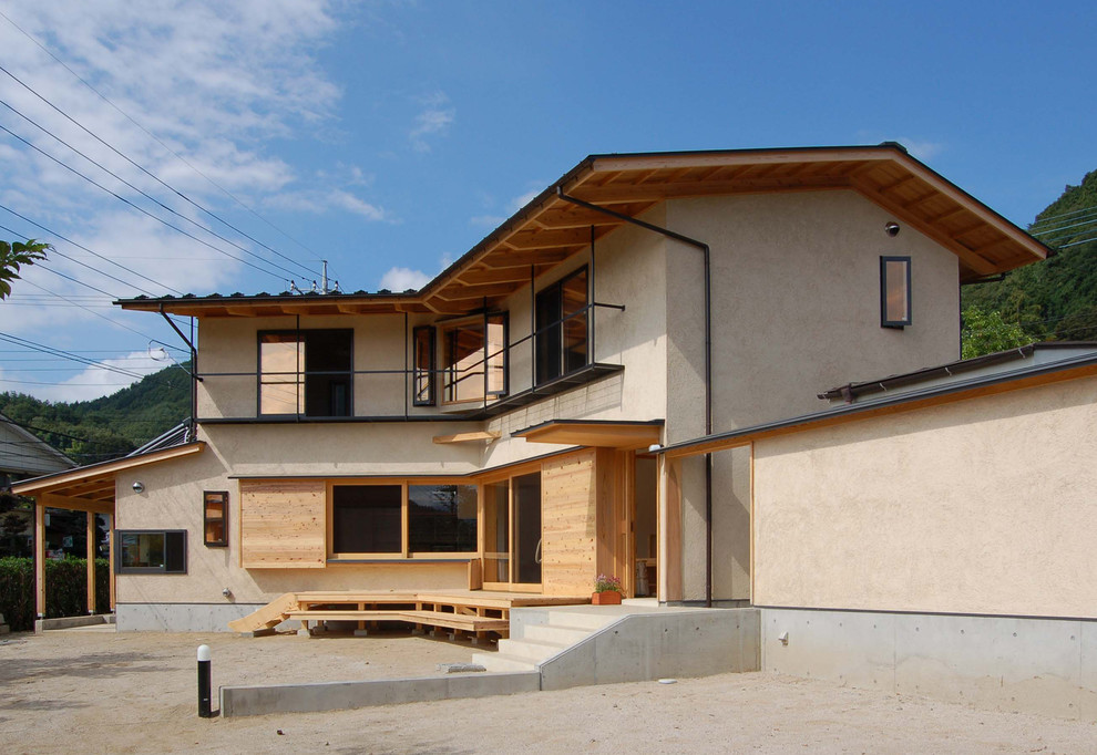 Inspiration pour une façade de maison marron traditionnelle avec un toit à deux pans.