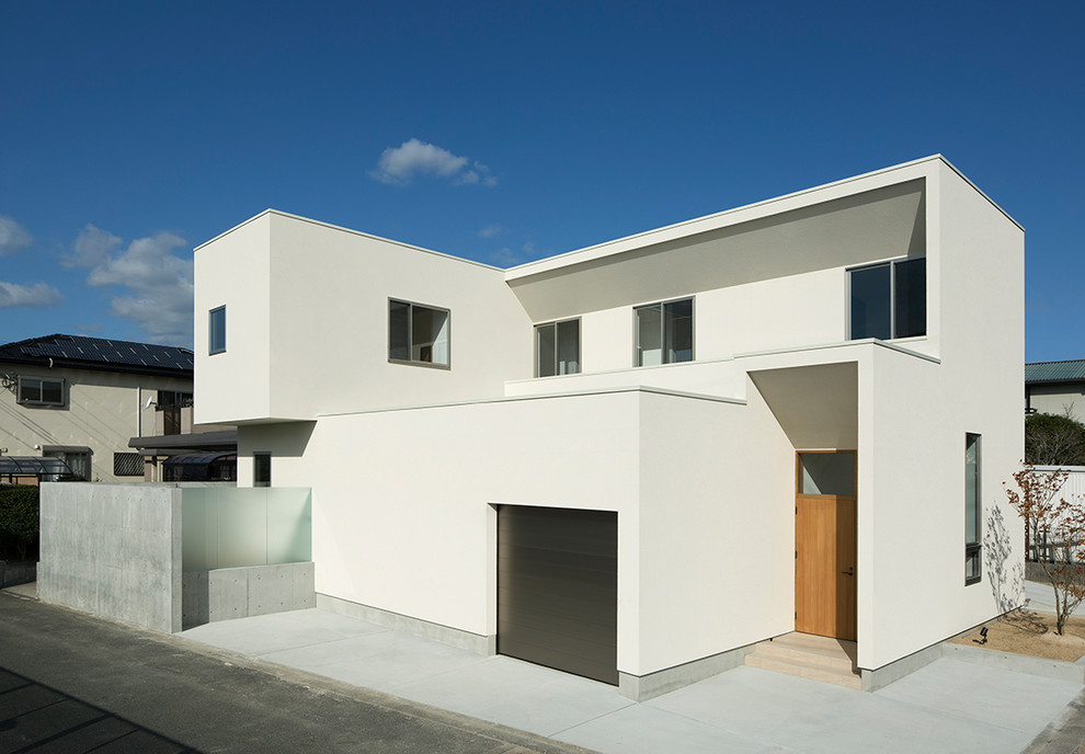 Inspiration for a mid-sized modern white two-story concrete fiberboard exterior home remodel in Other