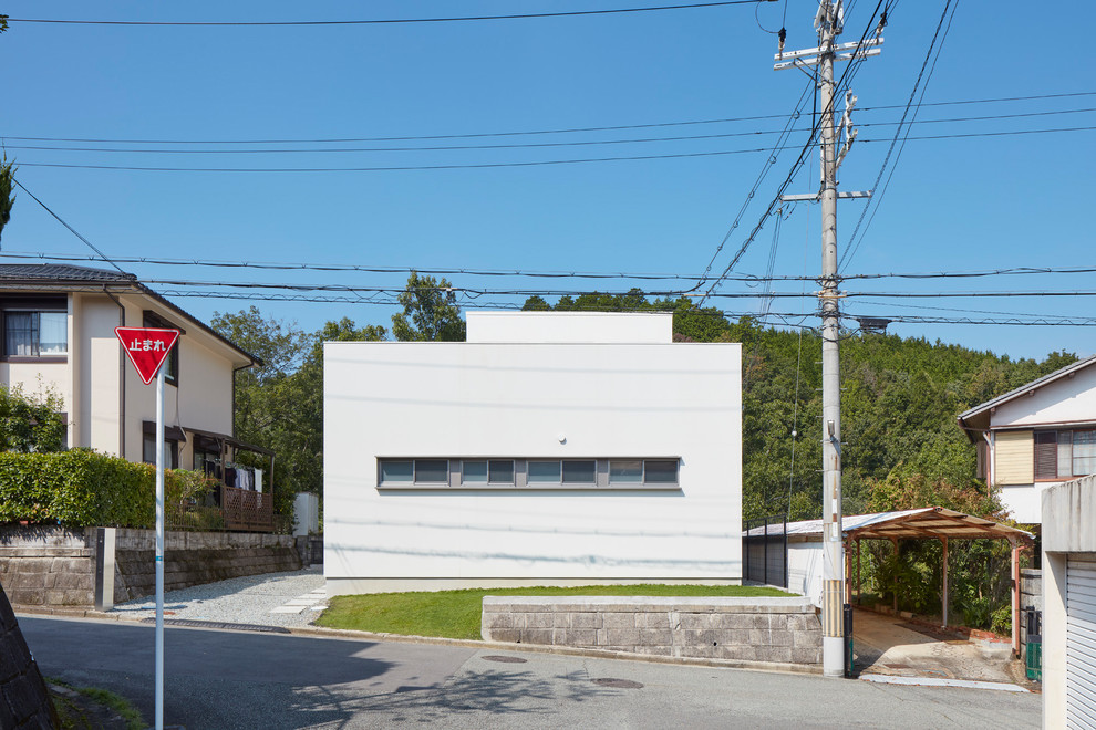 White modern house exterior in Osaka with a flat roof.