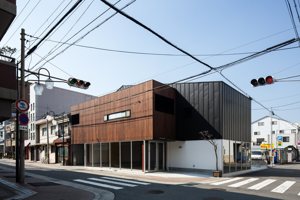 Inspiration for a contemporary two-story exterior home remodel in Osaka with a metal roof
