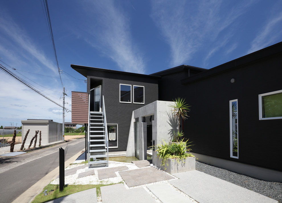 Small and black contemporary two floor detached house in Other with mixed cladding, a lean-to roof and a metal roof.