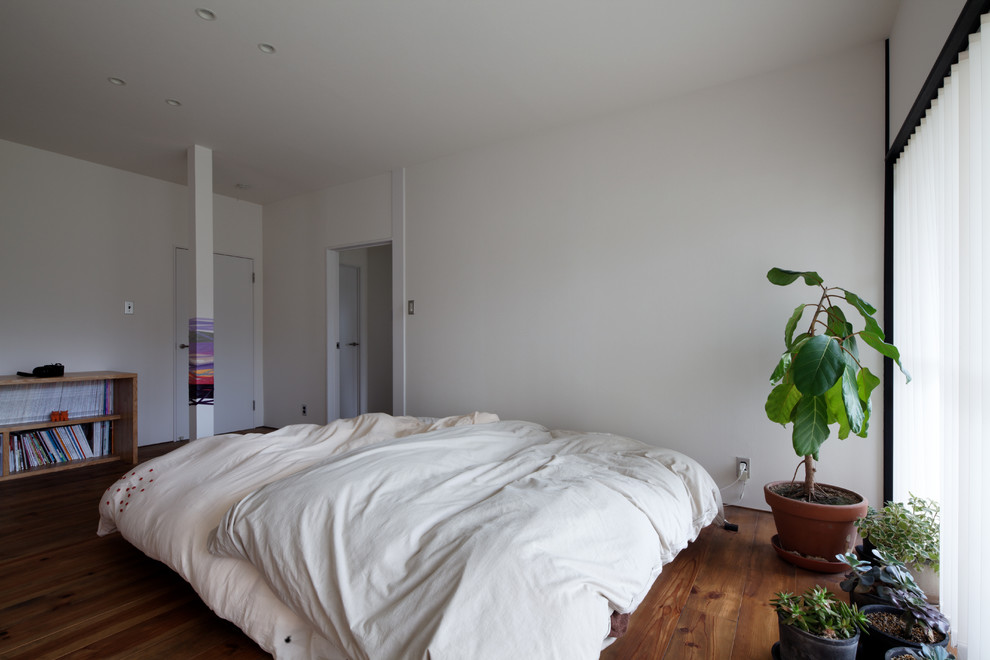 他の地域にあるコンテンポラリースタイルのおしゃれな寝室 (白い壁、無垢フローリング、茶色い床)