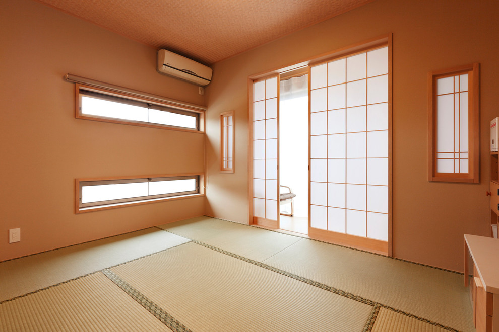 Inspiration for a mid-sized asian master tatami floor bedroom remodel in Other with brown walls and no fireplace