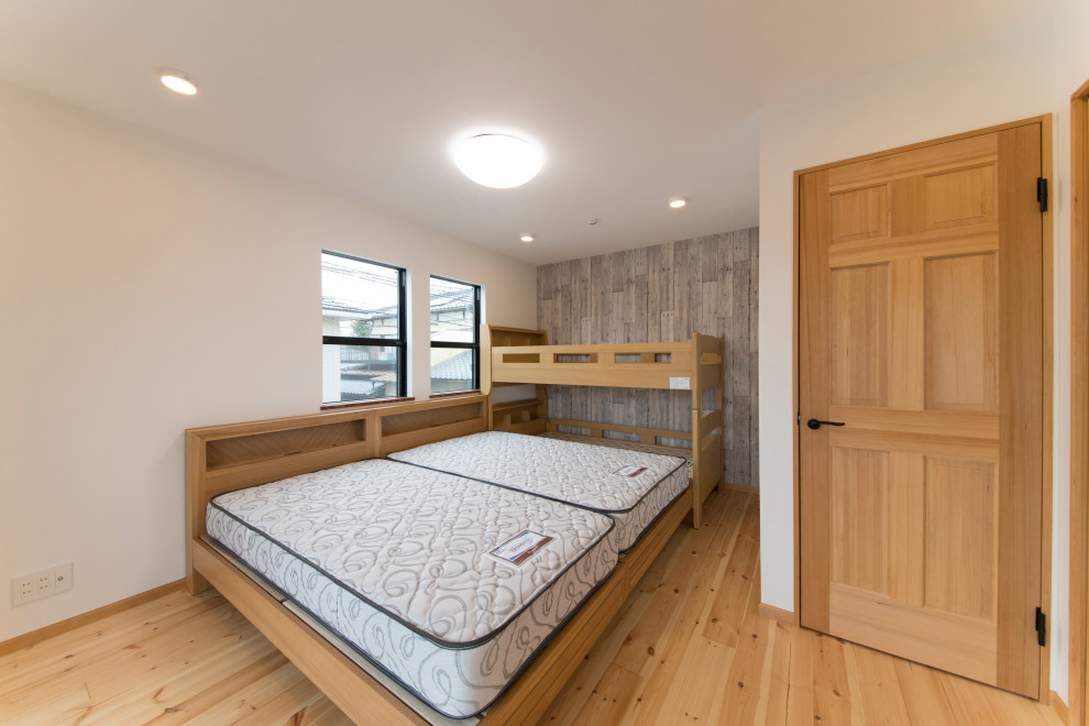 Example of a cottage master light wood floor and beige floor bedroom design in Other with white walls