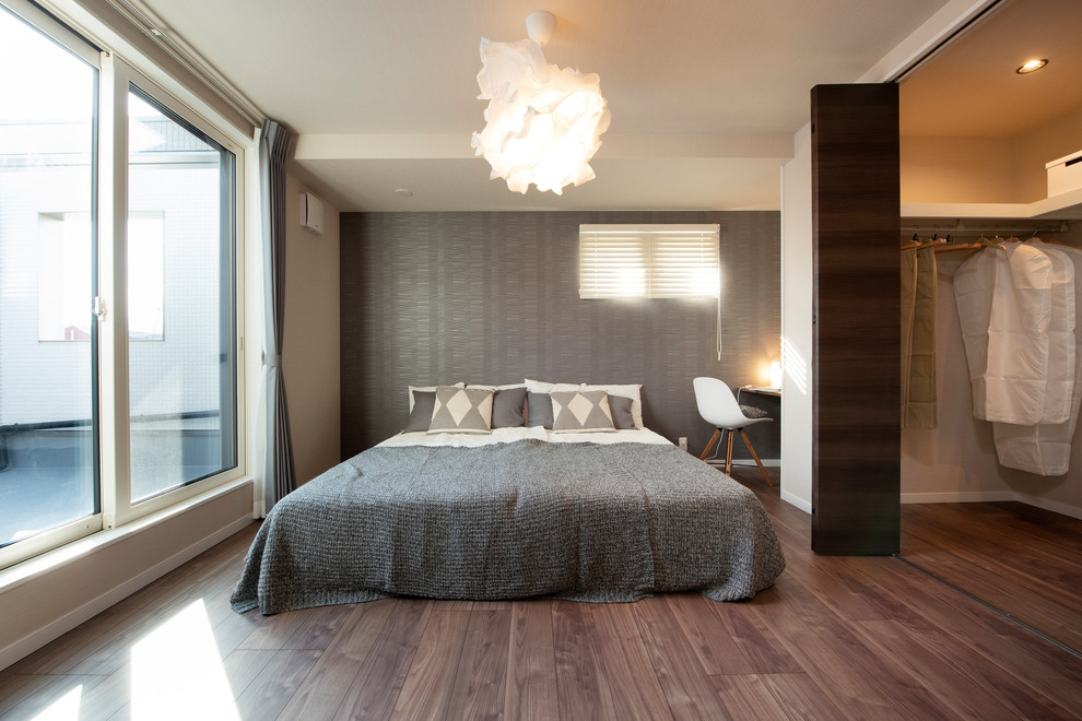 Mittelgroßes Modernes Hauptschlafzimmer ohne Kamin mit weißer Wandfarbe, dunklem Holzboden und braunem Boden in Sonstige