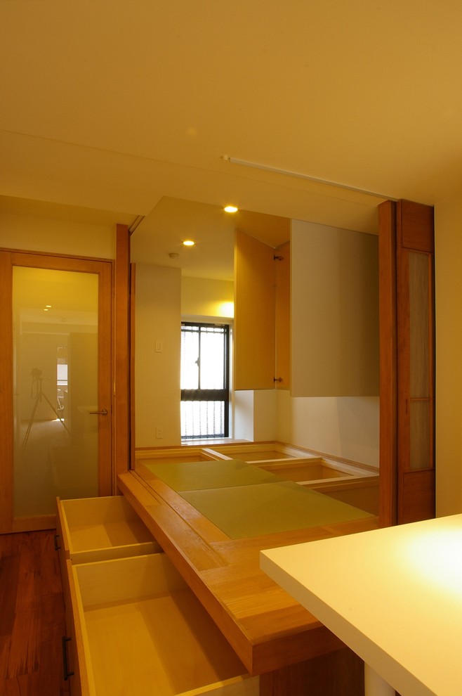 This is an example of a modern master bedroom in Other with white walls, tatami flooring and beige floors.