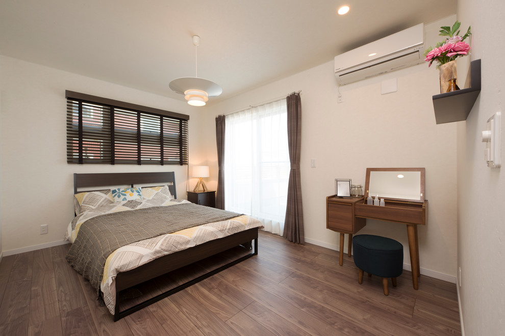 Diseño de dormitorio principal campestre de tamaño medio sin chimenea con paredes grises, suelo marrón y con escritorio