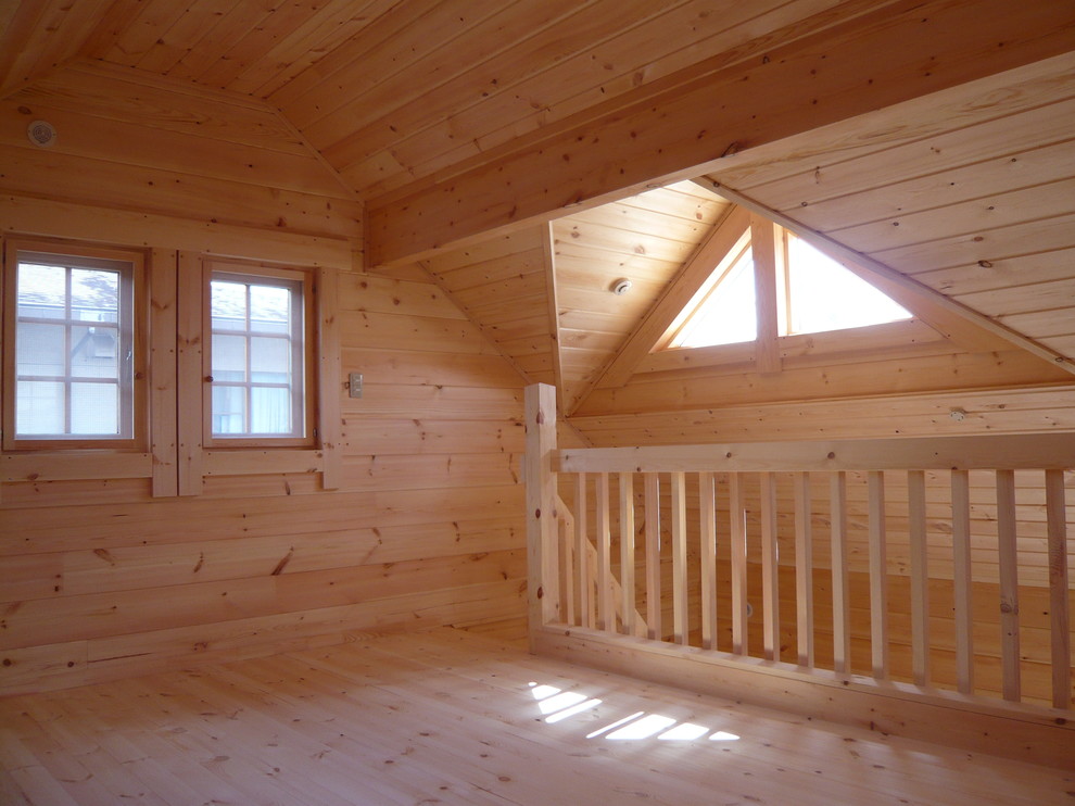 Photo of a scandinavian mezzanine bedroom in Other with light hardwood flooring.