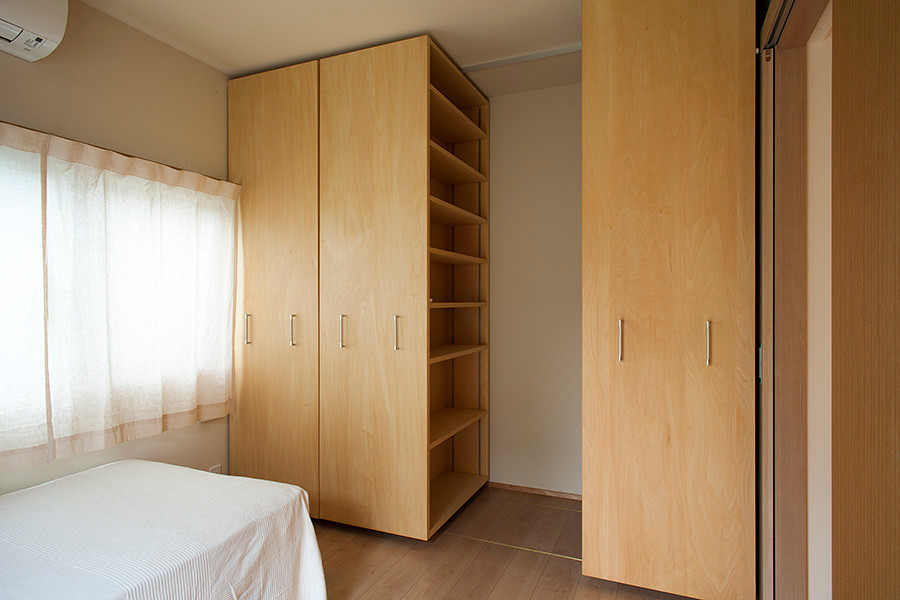 Идея дизайна: хозяйская спальня среднего размера в стиле кантри с белыми стенами, полом из фанеры, подвесным камином и бежевым полом