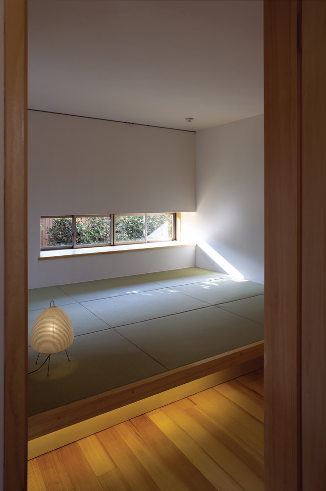 Ejemplo de dormitorio principal asiático con paredes blancas y tatami