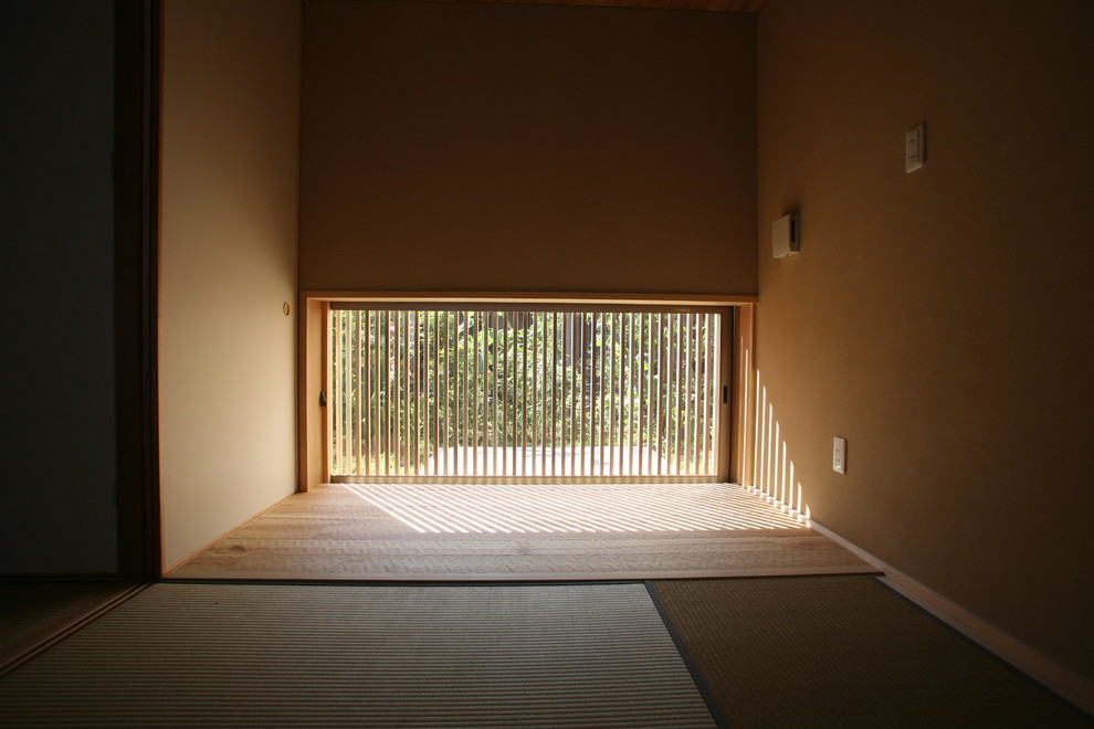 Asiatisk inredning av ett mellanstort huvudsovrum, med beige väggar och tatamigolv