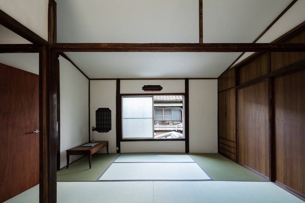 Small world-inspired master bedroom in Kyoto with white walls, tatami flooring, no fireplace and green floors.