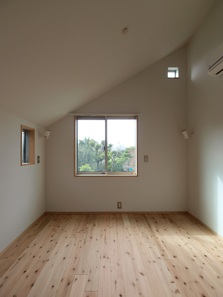 Idéer för ett minimalistiskt sovrum, med vita väggar, ljust trägolv och beiget golv