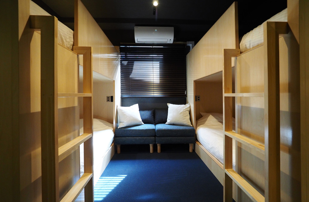 Idee per una camera da letto stile loft etnica con pareti nere, moquette, nessun camino e pavimento blu