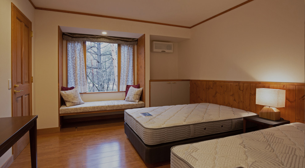 Ejemplo de dormitorio actual con paredes blancas y suelo marrón