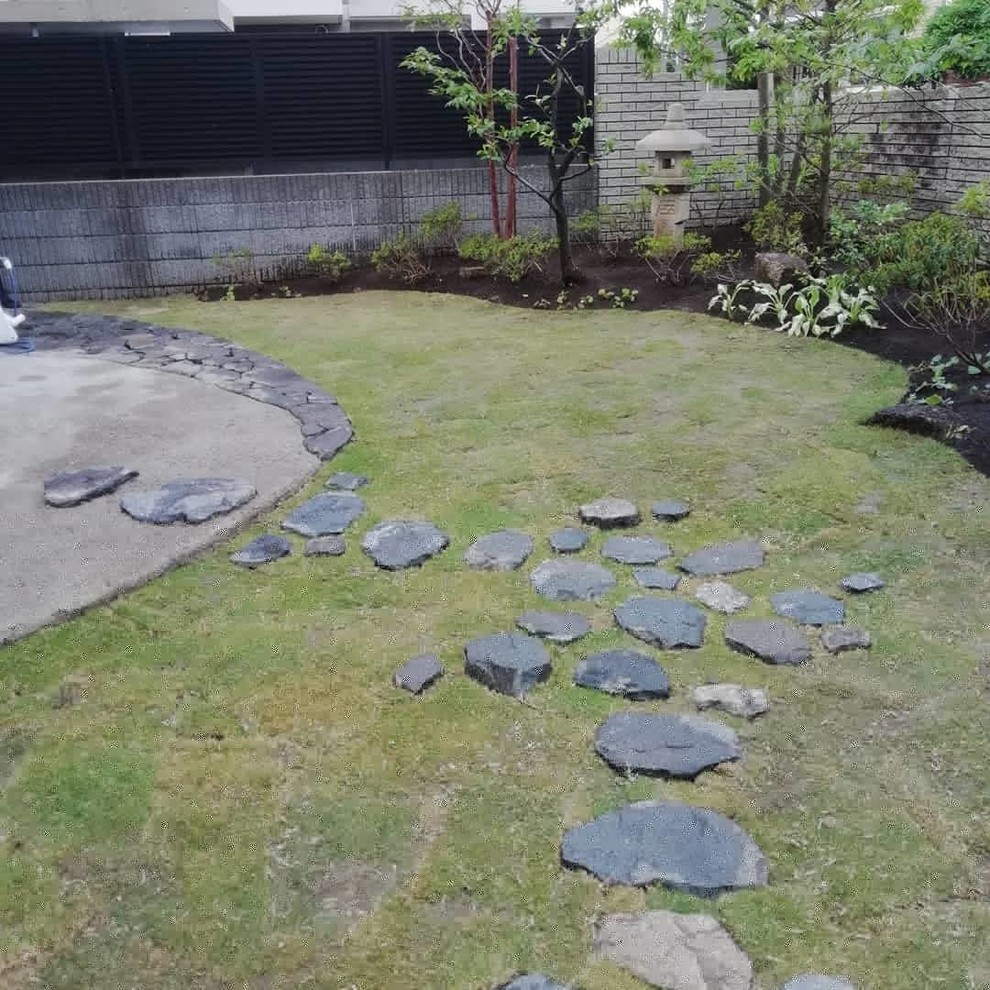 World-inspired garden in Tokyo with natural stone paving.