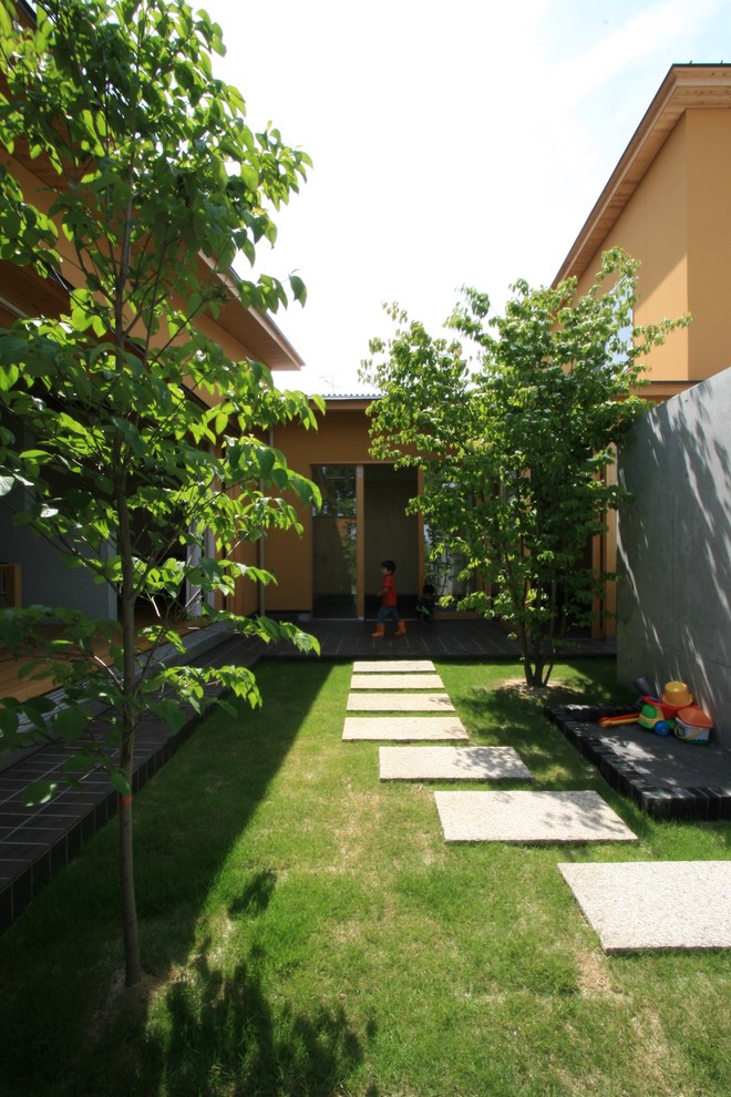 Cette image montre un jardin nordique de taille moyenne et l'été avec un mur de soutènement, une exposition ensoleillée et des pavés en béton.