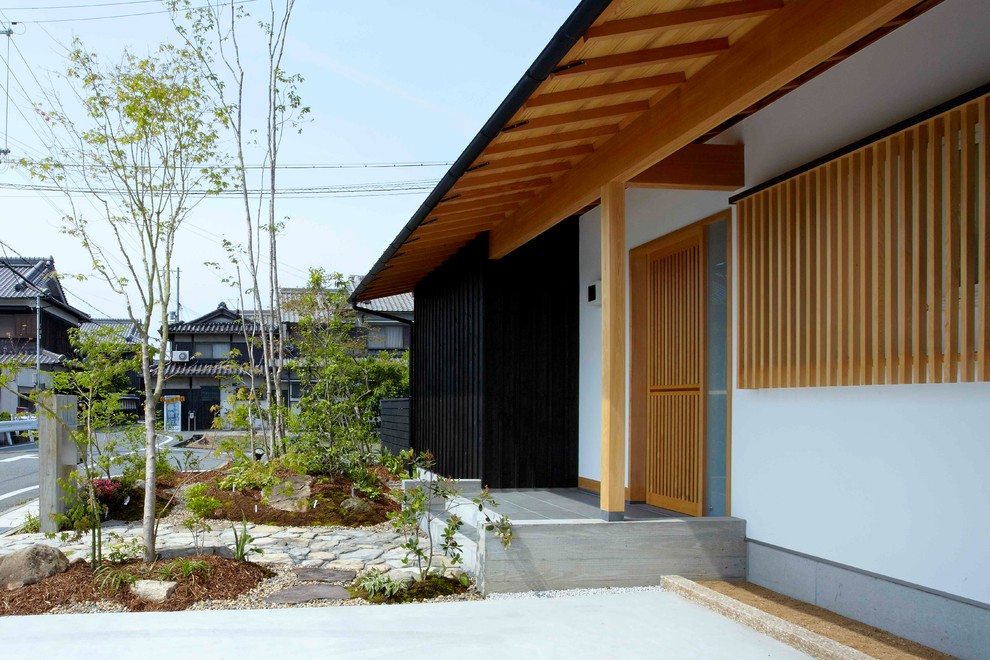 Idee per un giardino etnico esposto in pieno sole davanti casa con pavimentazioni in pietra naturale e un ingresso o sentiero