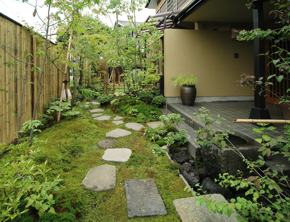 Imagen de jardín de estilo zen de tamaño medio en verano en patio delantero con jardín francés, exposición total al sol y adoquines de piedra natural