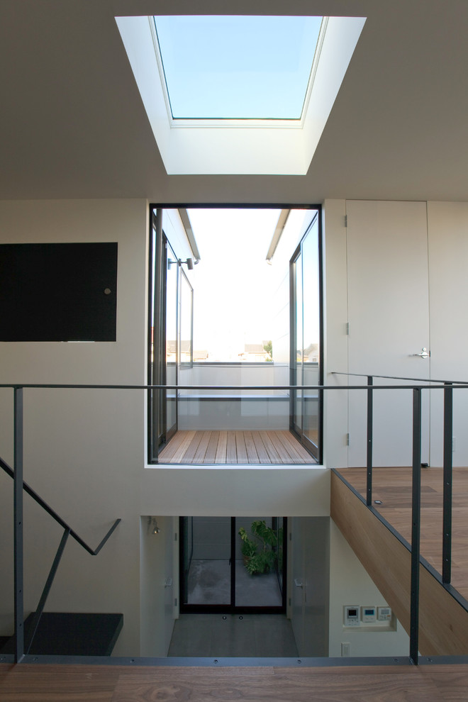 Стильный дизайн: коридор среднего размера: освещение в стиле модернизм с белыми стенами, темным паркетным полом, коричневым полом, потолком с обоями и обоями на стенах - последний тренд