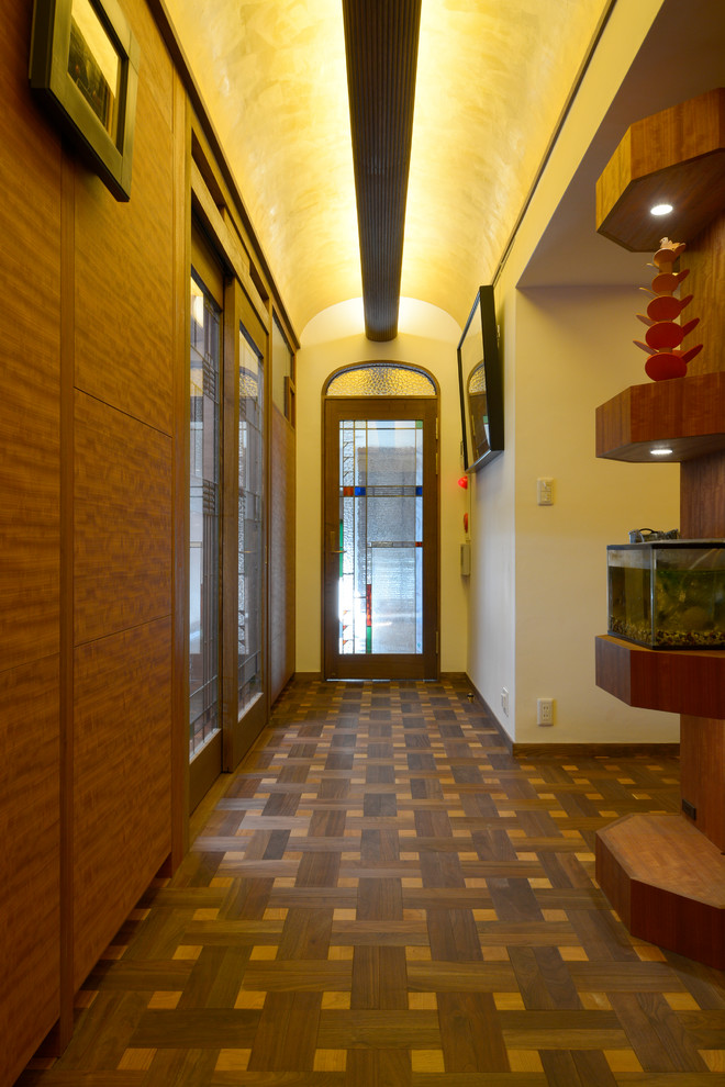 Diseño de recibidores y pasillos minimalistas extra grandes con paredes blancas, suelo de madera oscura y suelo marrón