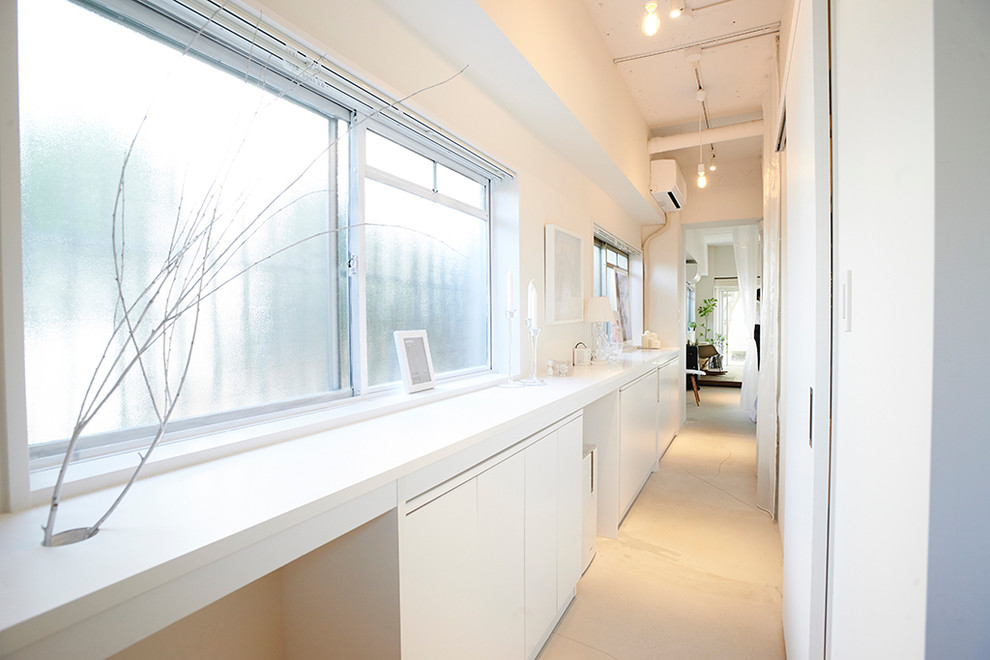 Inspiration for a large contemporary beige floor hallway remodel in Tokyo with white walls