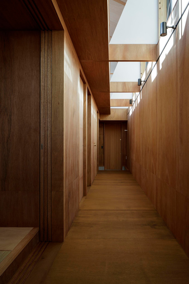 Idee per un piccolo ingresso o corridoio moderno con pareti marroni, pavimento in compensato, pavimento marrone, soffitto in legno e pareti in legno