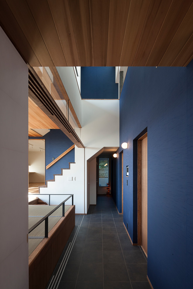 Cette photo montre un couloir asiatique avec un mur bleu et un sol noir.