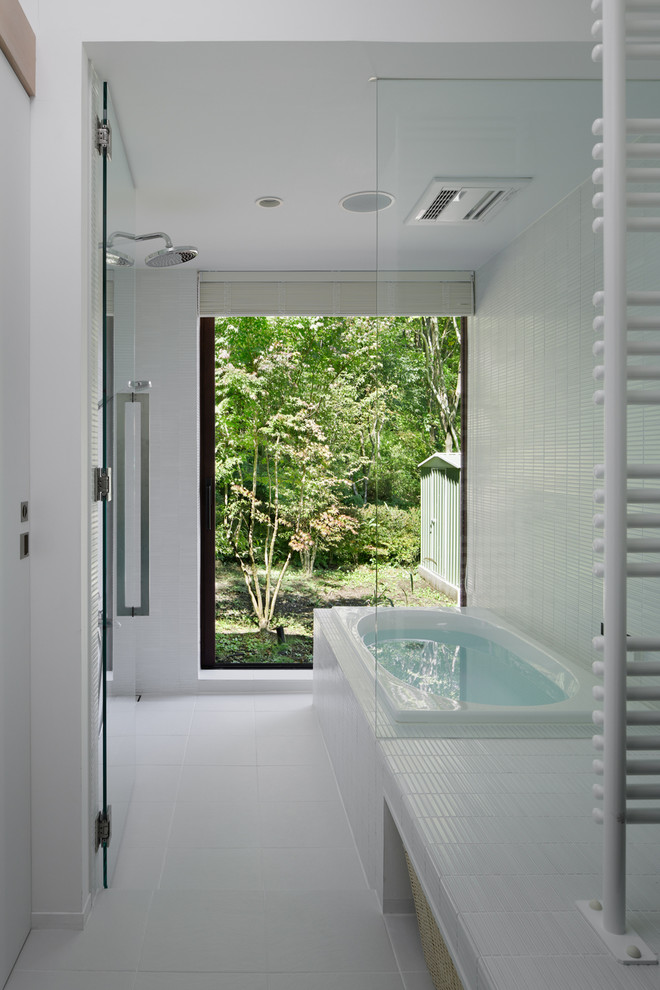 Идея дизайна: главная ванная комната в стиле модернизм с полновстраиваемой ванной, двойным душем, белой плиткой и керамической плиткой