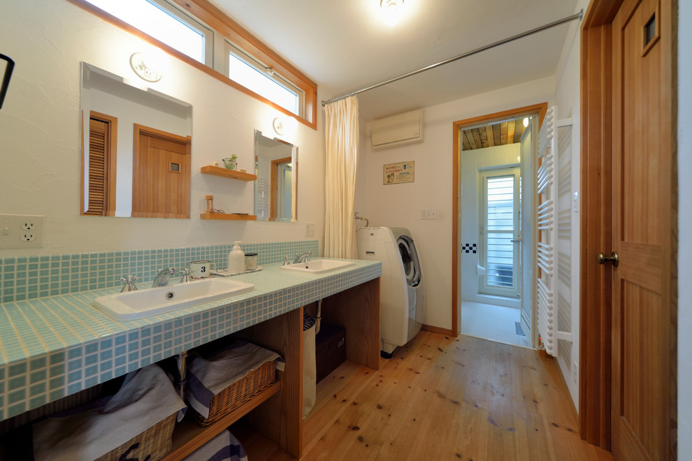 Medium tone wood floor and brown floor bathroom photo in Other with open cabinets, medium tone wood cabinets and white walls