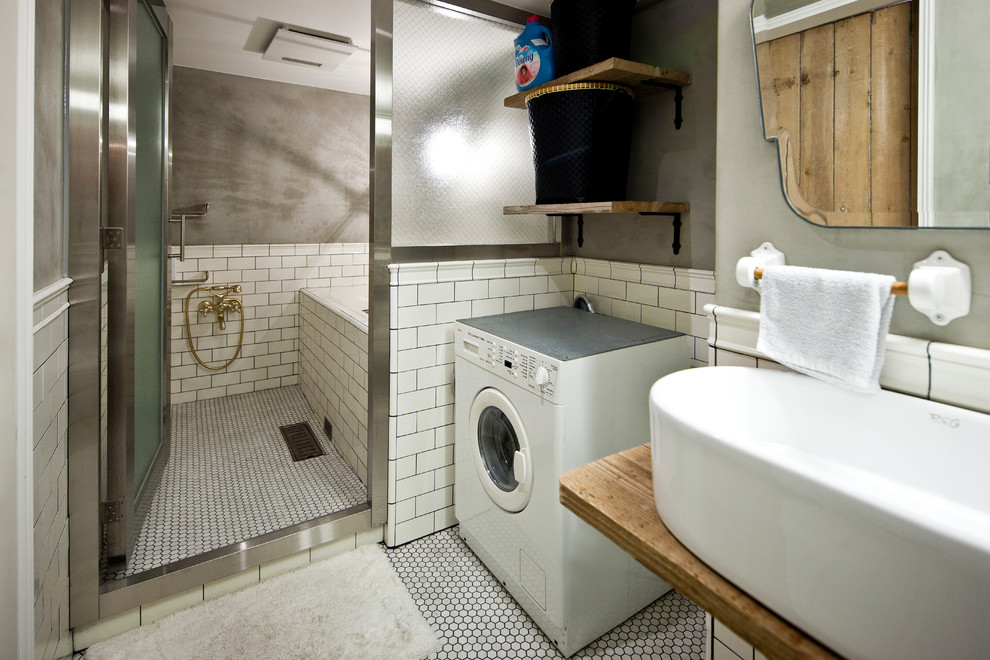 Immagine di una stanza da bagno industriale con vasca ad angolo, doccia aperta, piastrelle bianche, pareti grigie, lavabo a bacinella, pavimento bianco e doccia aperta