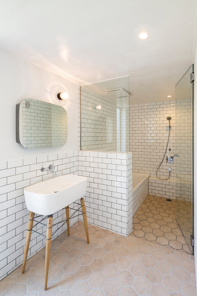 Inredning av ett modernt litet en-suite badrum, med vit kakel, vita väggar, ett avlångt handfat, beiget golv, keramikplattor och klinkergolv i porslin