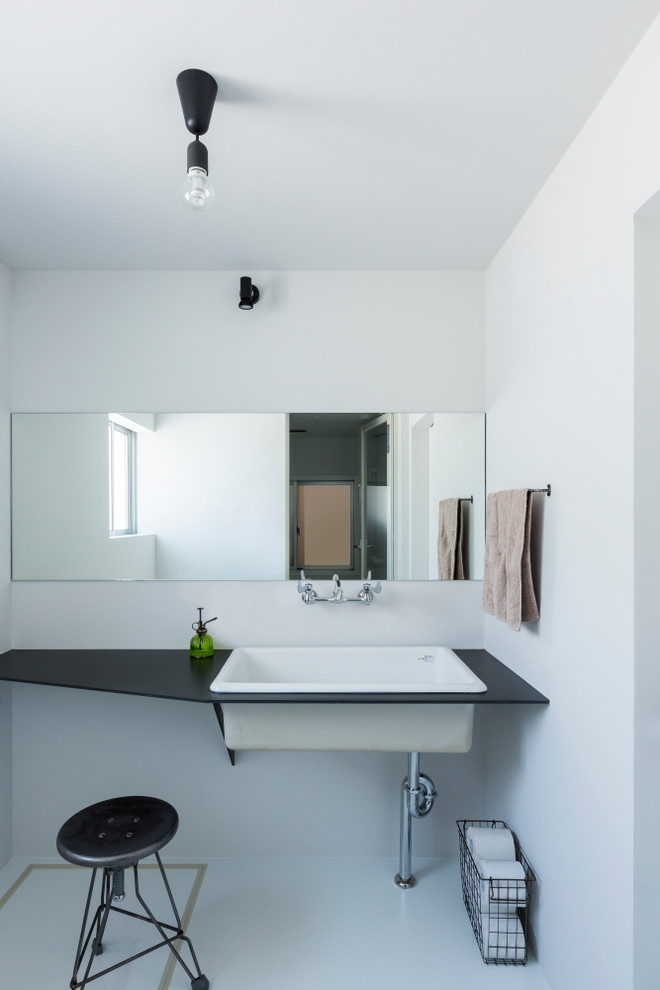 他の地域にある低価格の中くらいなラスティックスタイルのおしゃれな浴室 (オープンシェルフ、黒いキャビネット、白い壁、クッションフロア、白い床) の写真