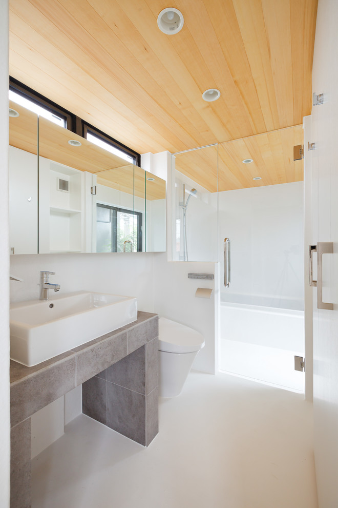 На фото: ванная комната в современном стиле с угловой ванной, открытым душем, белыми стенами, настольной раковиной, белым полом и открытым душем с