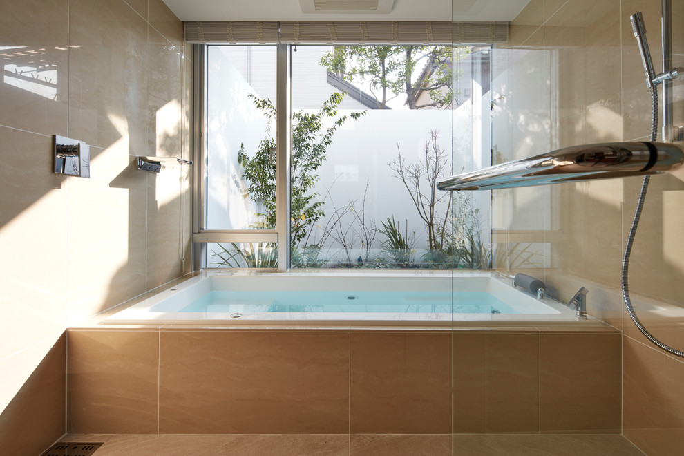 Réalisation d'une douche en alcôve principale minimaliste de taille moyenne avec un carrelage beige, un mur beige et une baignoire posée.