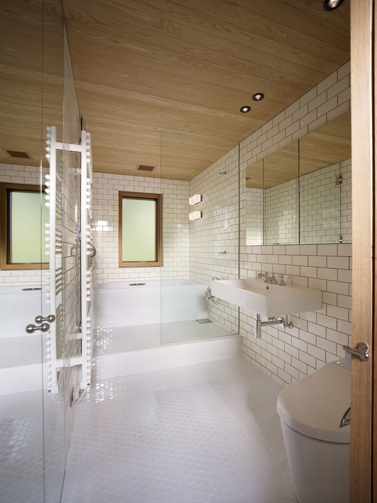 Modernes Badezimmer mit offener Dusche, Wandtoilette, weißen Fliesen, Metrofliesen, weißer Wandfarbe, Mosaik-Bodenfliesen, Wandwaschbecken, weißem Boden und offener Dusche in Tokio