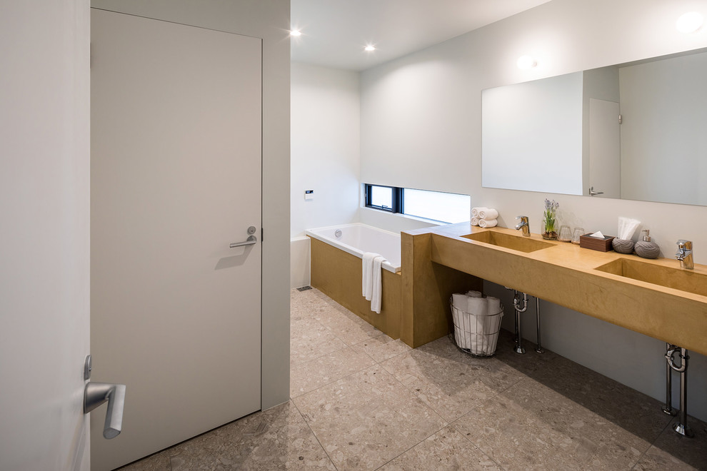 Contemporary bathroom in Other with open cabinets, a corner bath, white walls and brown floors.