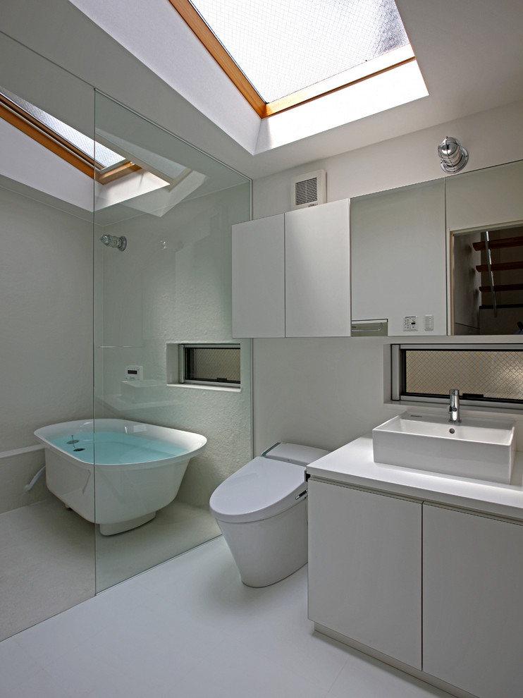 Design ideas for a small contemporary ensuite bathroom in Tokyo with beaded cabinets, white cabinets, a freestanding bath, a one-piece toilet, white walls, lino flooring, a vessel sink and white floors.