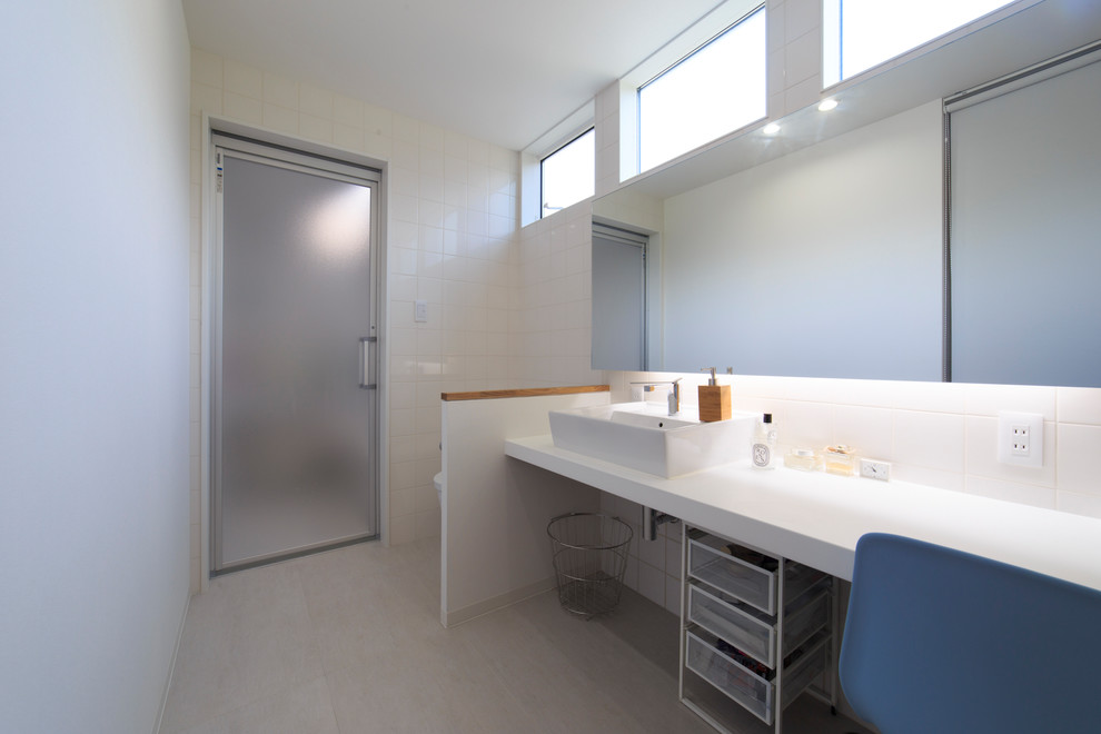 Medium sized contemporary bathroom in Other with a one-piece toilet, white tiles, porcelain tiles, white walls, a vessel sink and white floors.